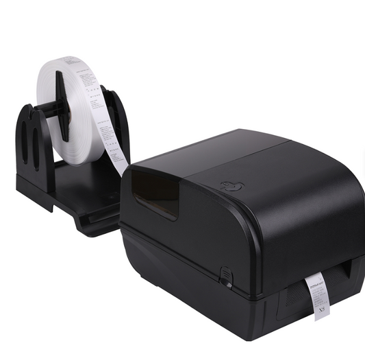 Black label printer with a roll of white labels on a white background